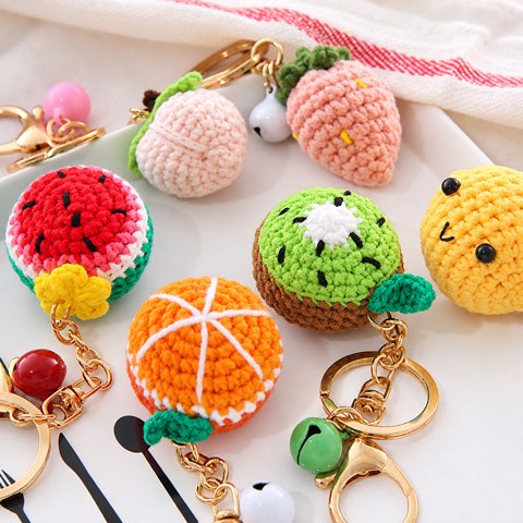 An assortment of crochet fruit keyrings with gold clasps