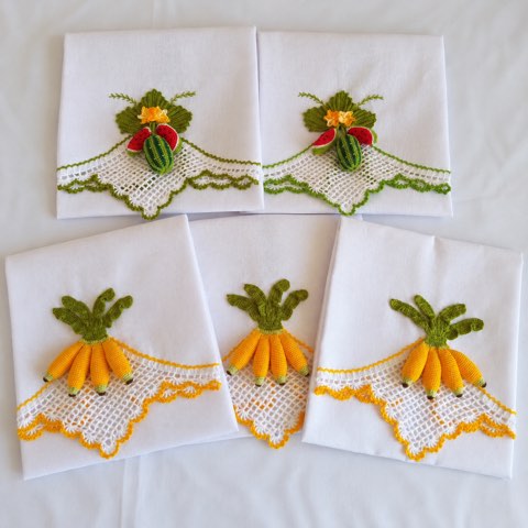 A pair of white towels finished with crochet carrot borders